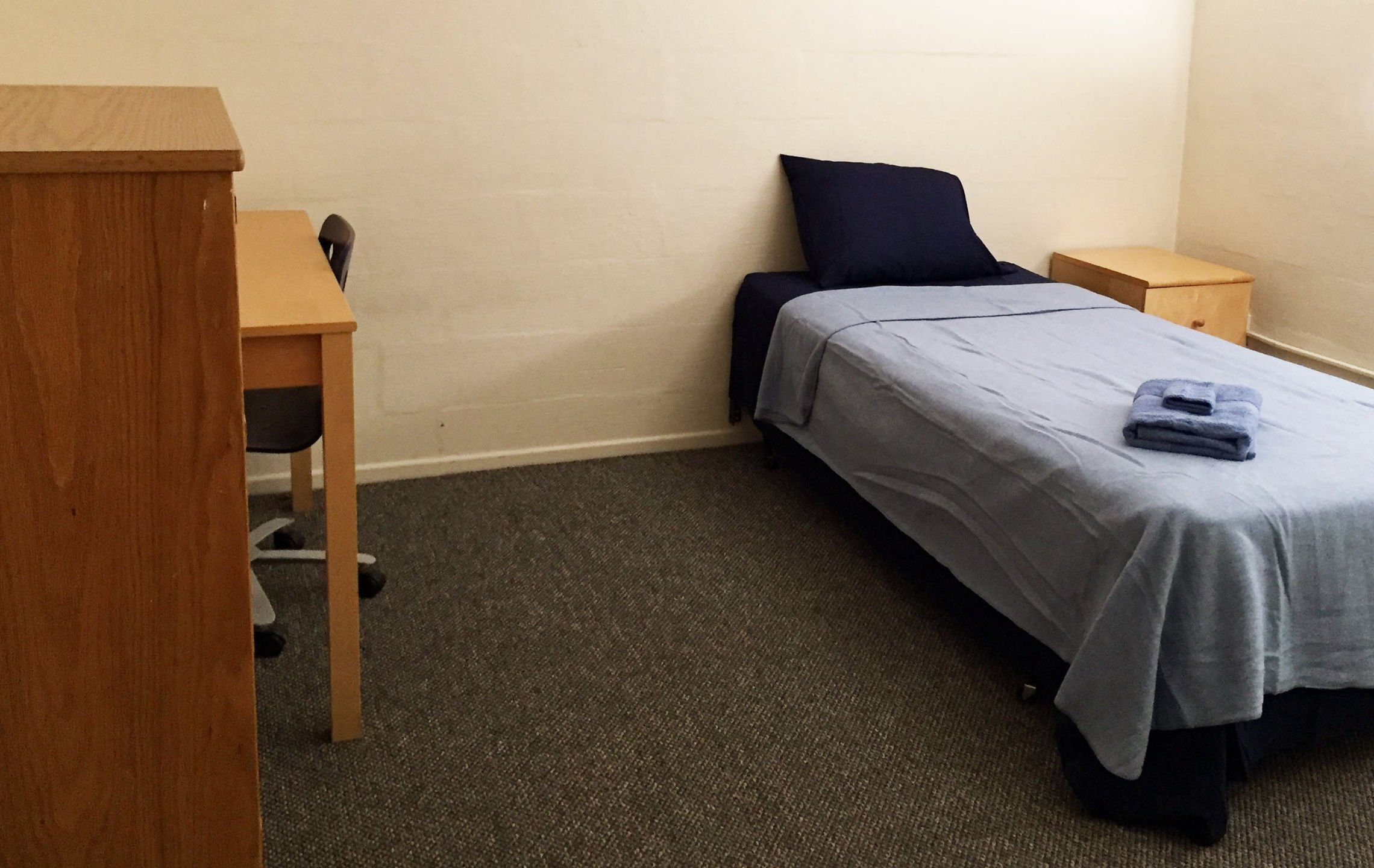 a bed and desk in a room