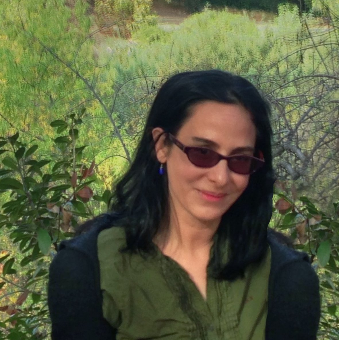 a woman wearing sunglasses and smiling