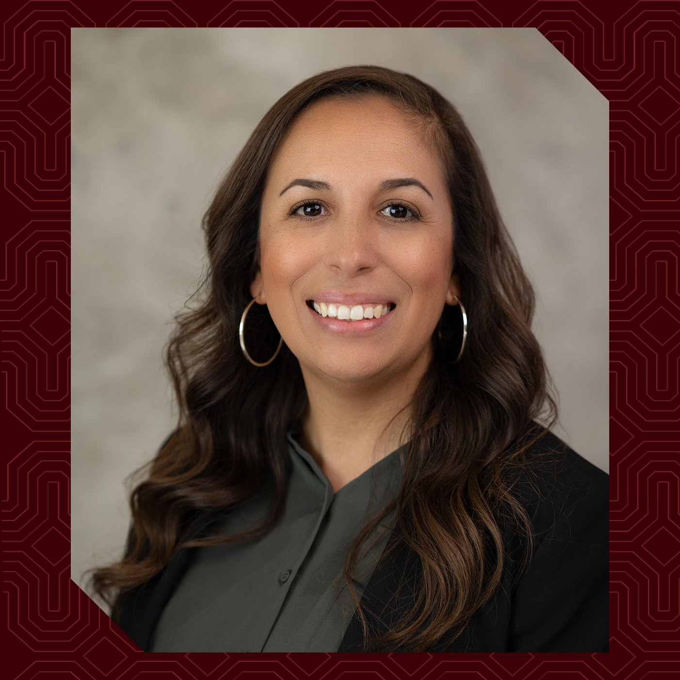 a woman with long brown hair smiling