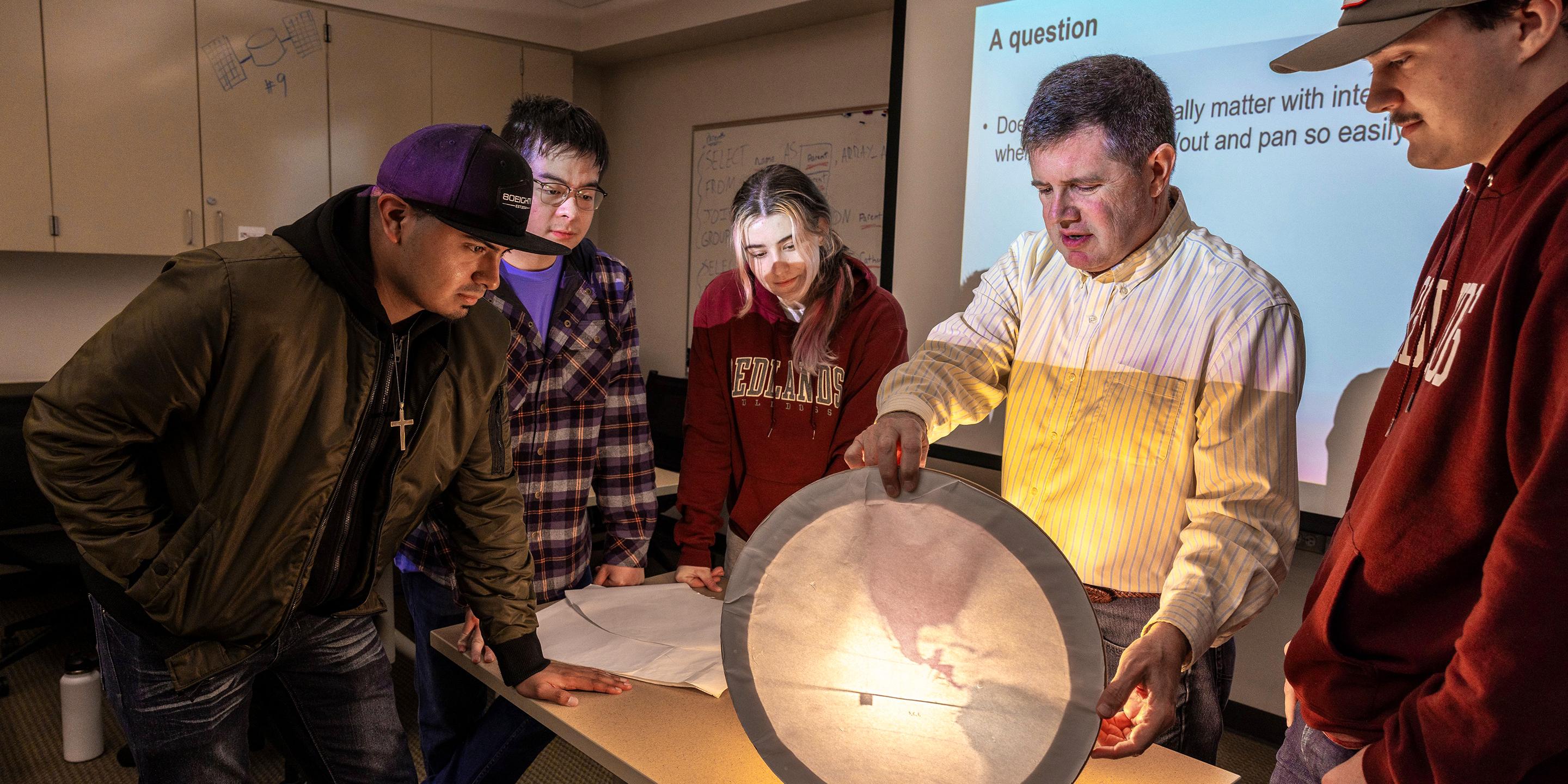 a group of people looking at a map