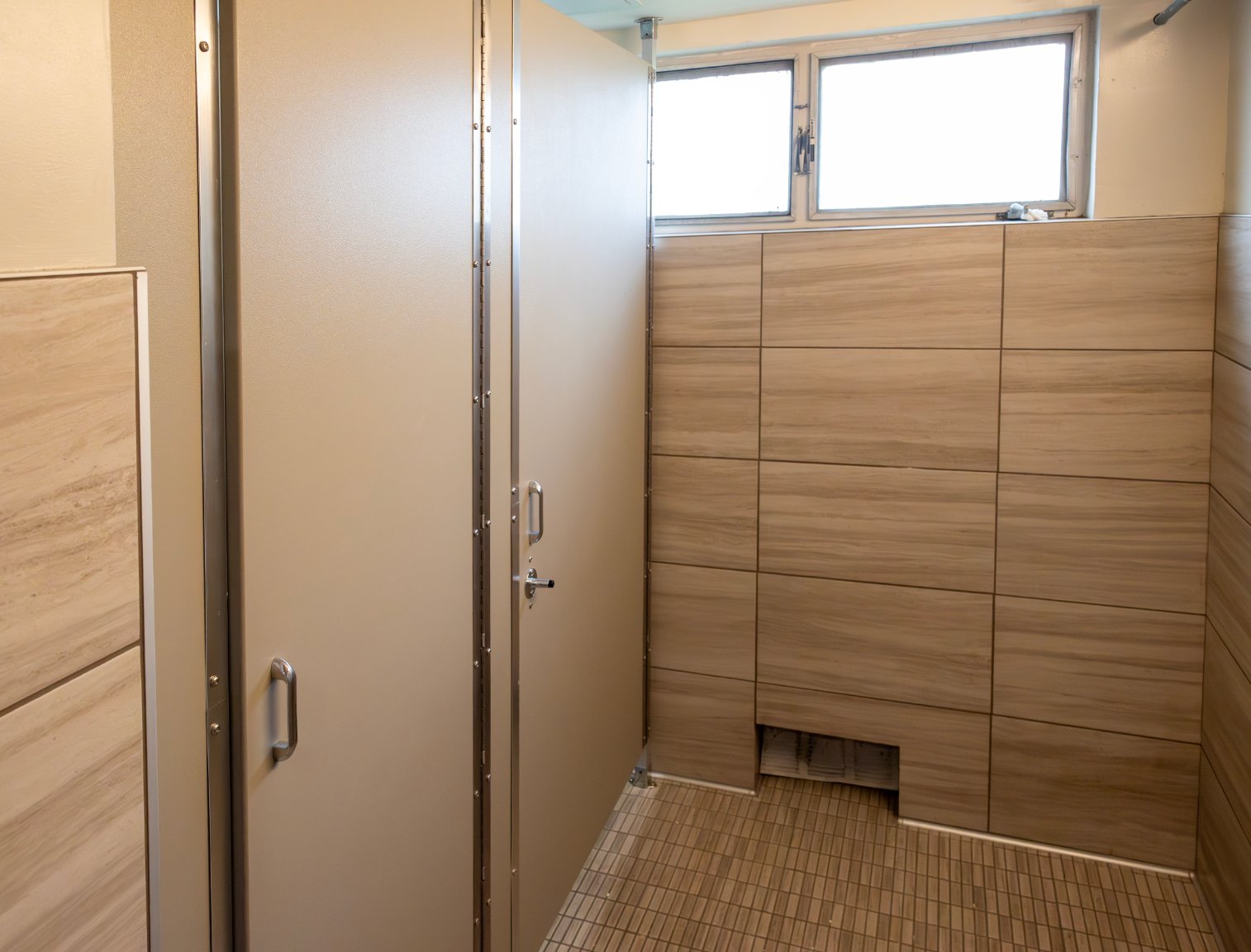 a bathroom with a shower stall and a window