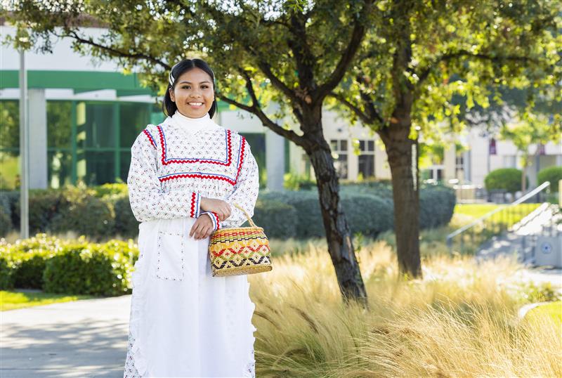 a woman in a white dress holding a basket
