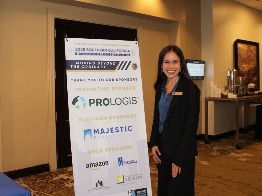 a woman standing next to a sign