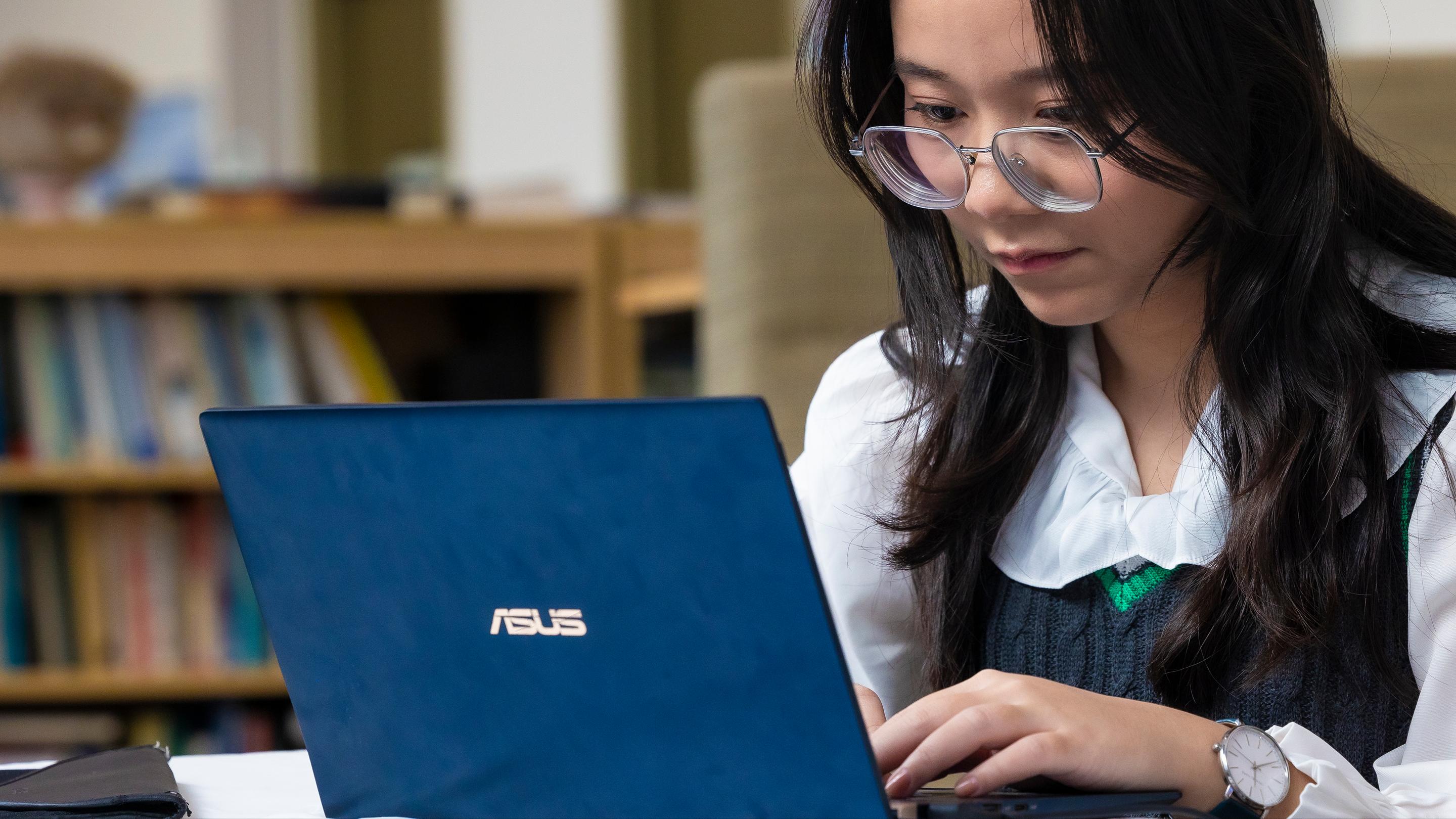 a woman looking at a laptop