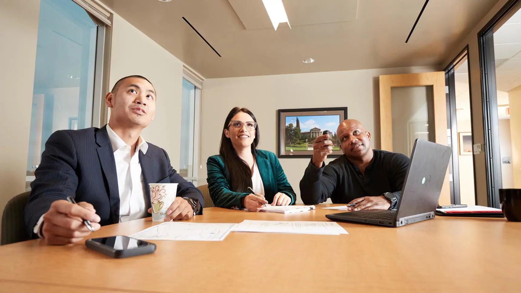 Business students sitting at conference table.