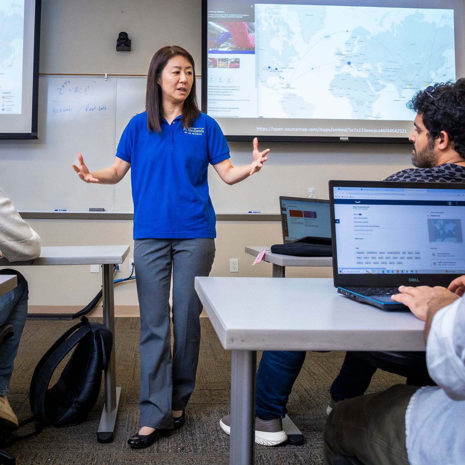 a woman standing in front of a group of people