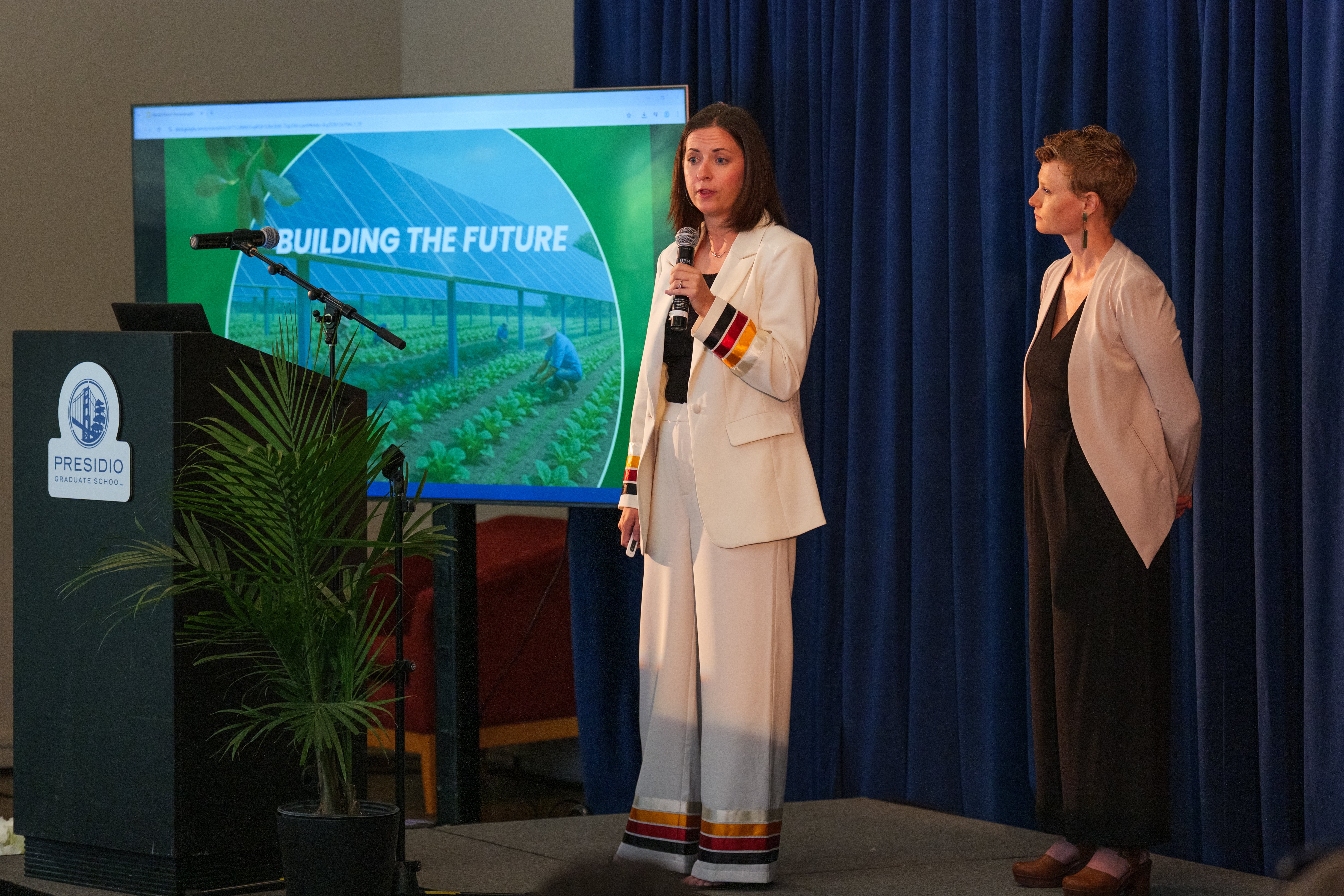 a woman standing in front of a screen