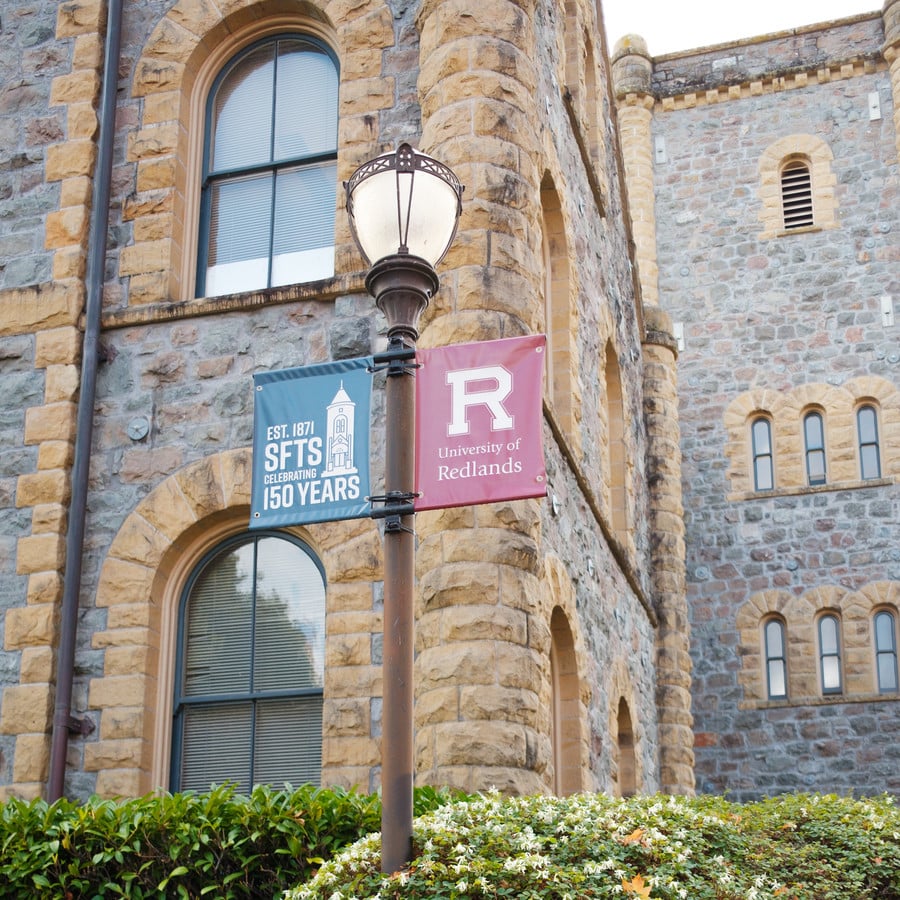 a street light in front of a stone building