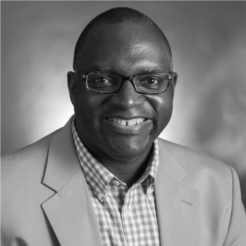 a man wearing glasses and a suit