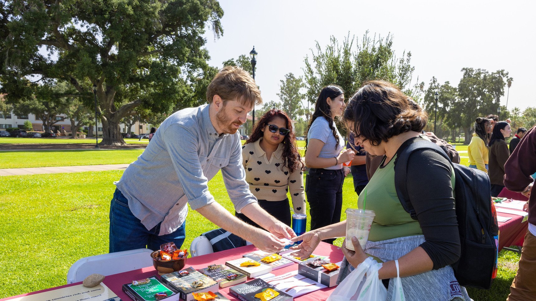 a man and woman at a table with a table with items on it