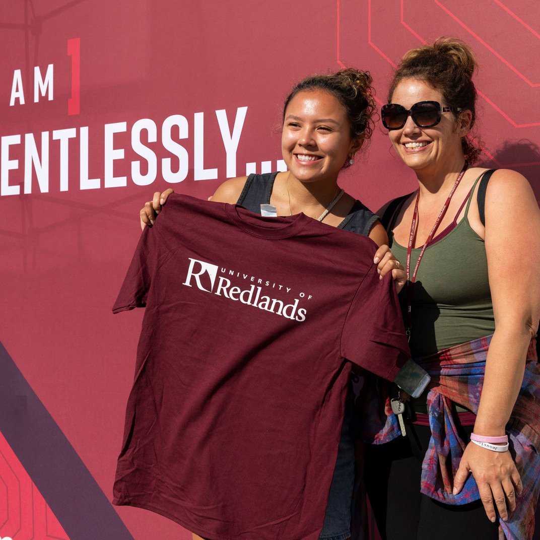 two women holding a shirt