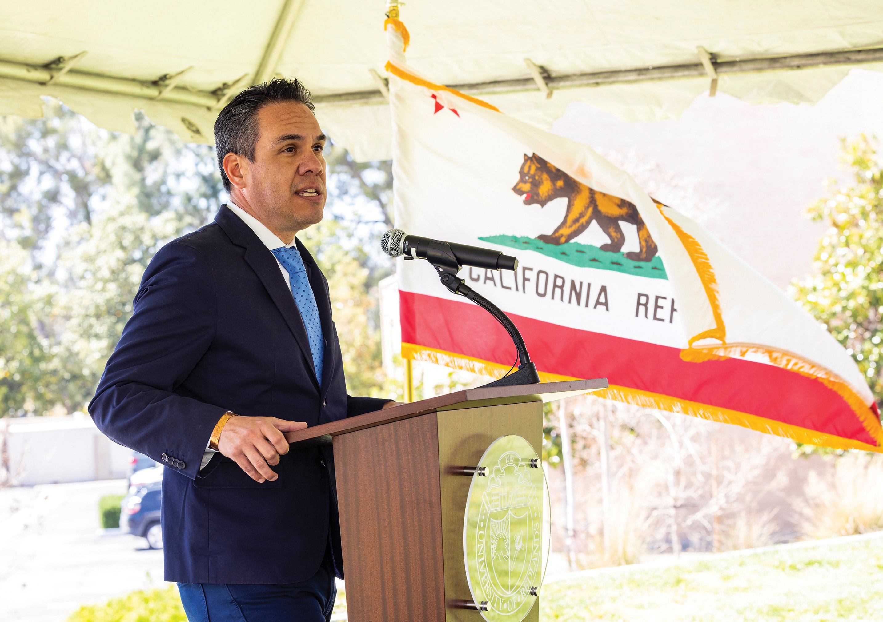 a man standing at a podium with a microphone