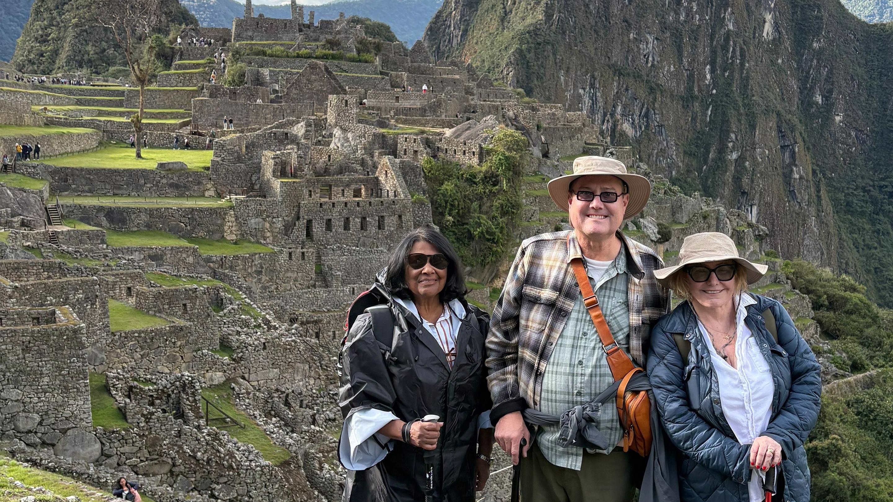 a group of people standing in front of a stone building