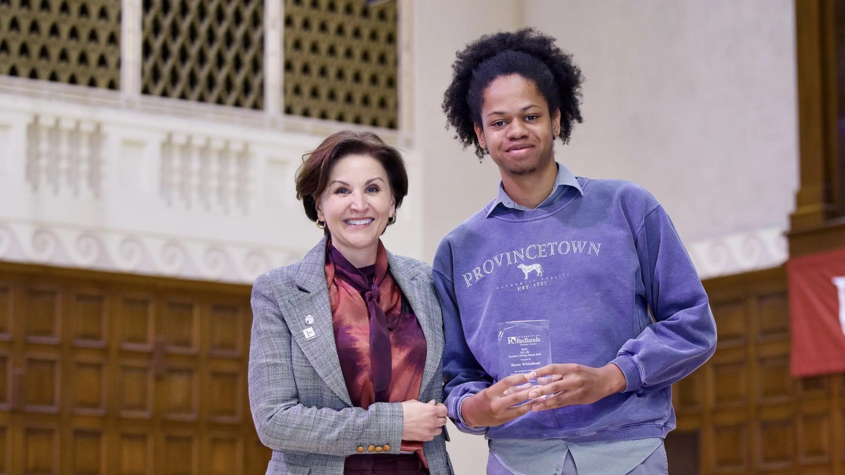 a man and woman holding a trophy