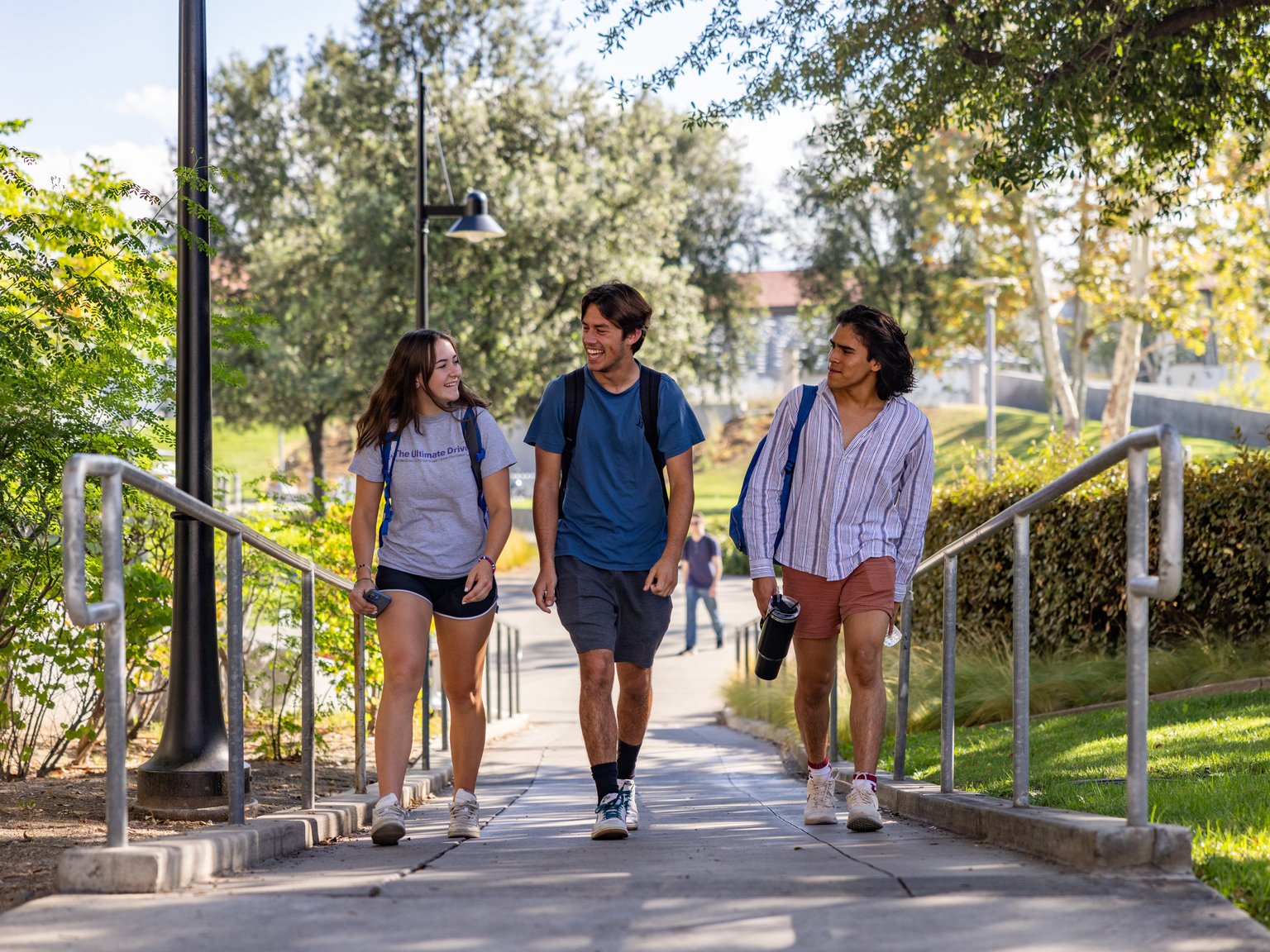 a group of people walking down a sidewalk