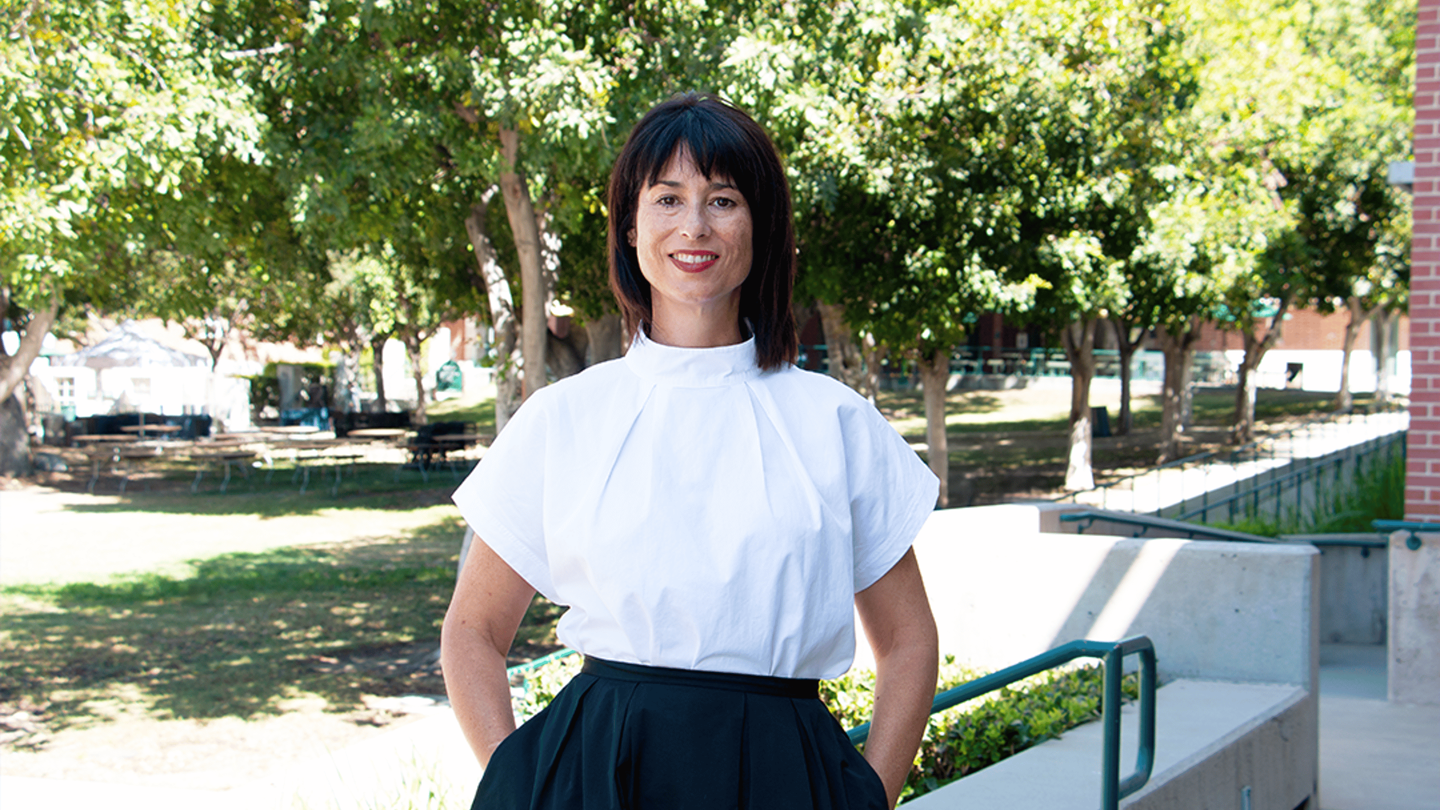 a woman in a white shirt and black skirt