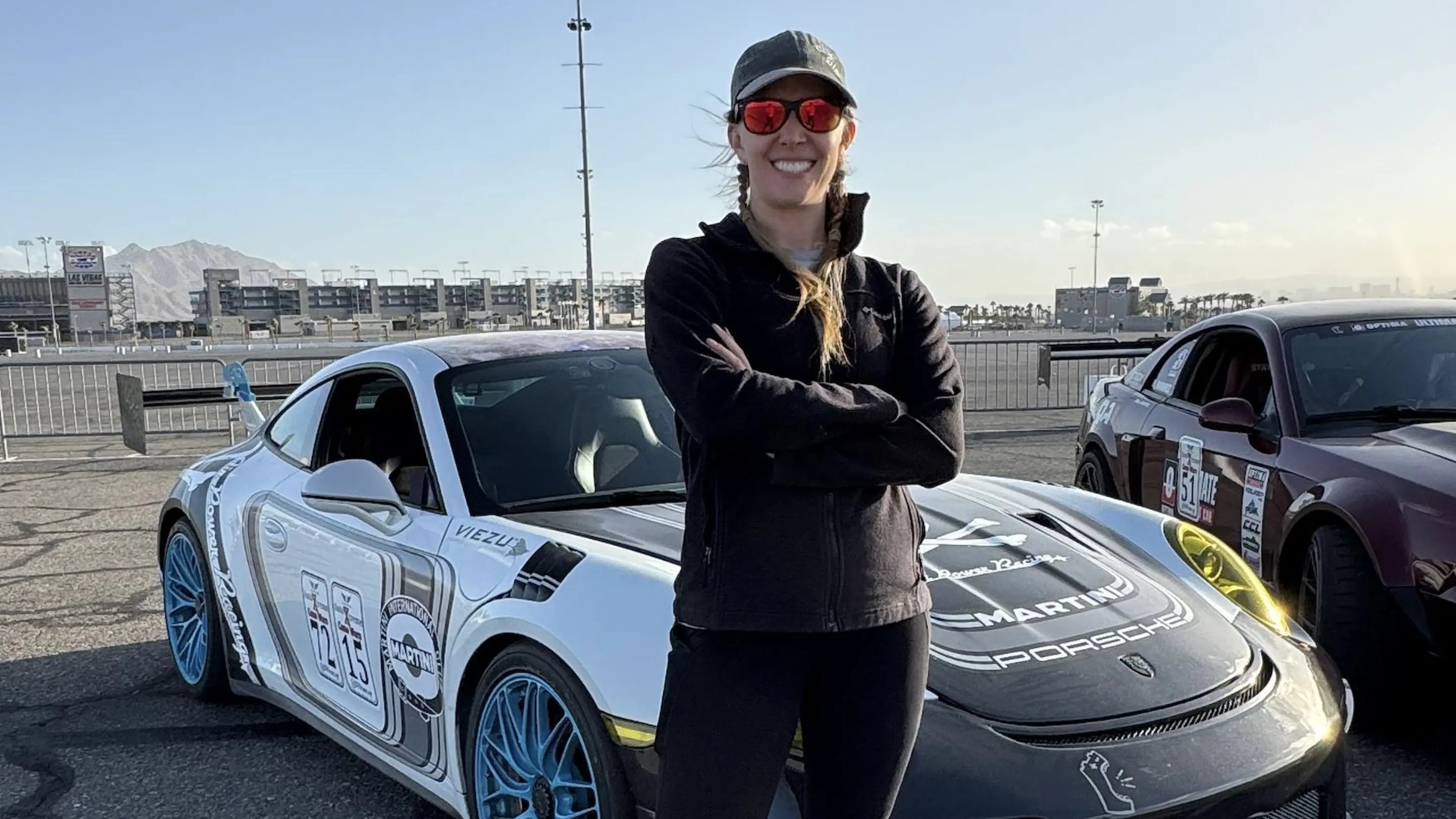 a woman standing in front of a car