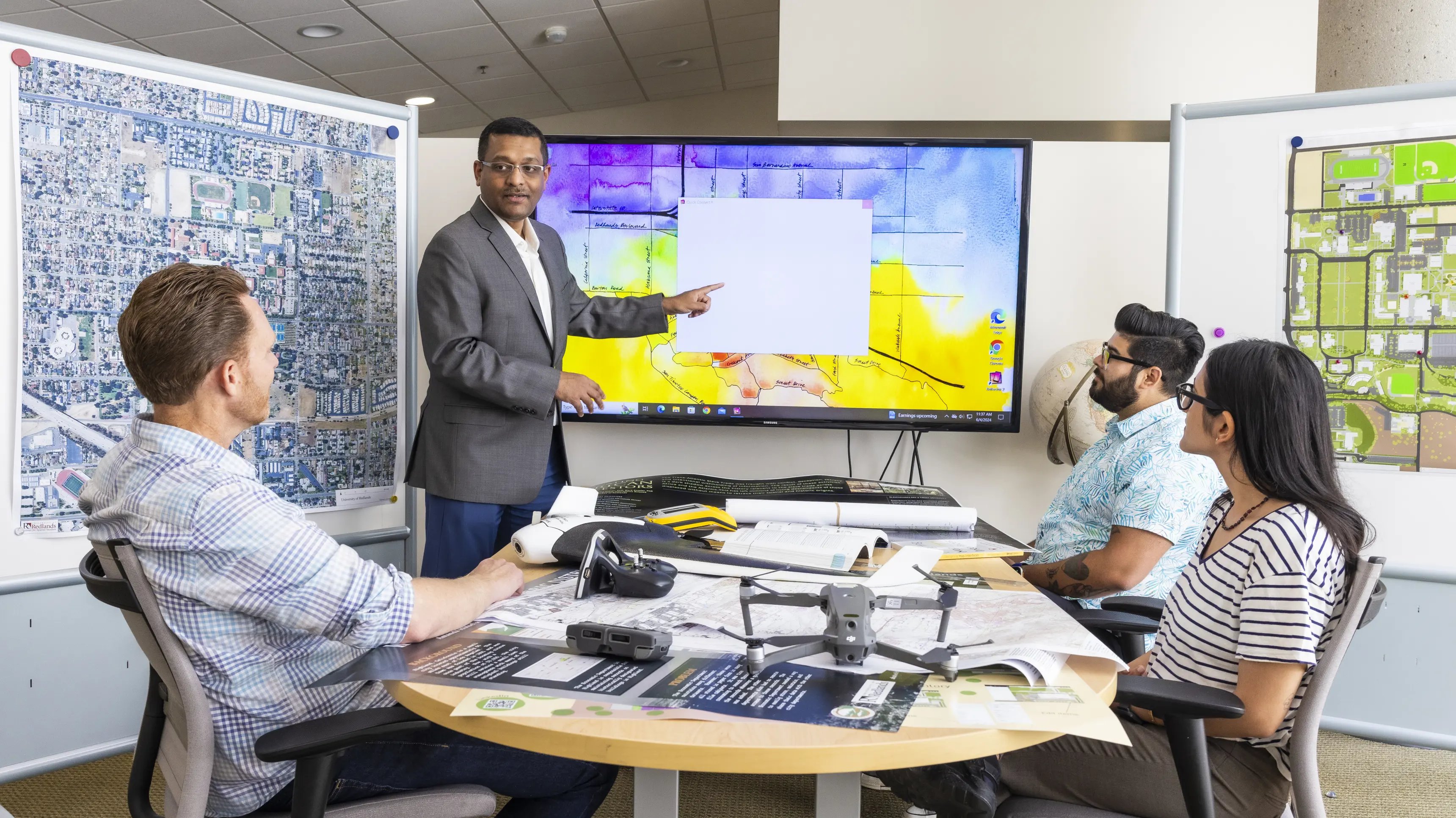 a man pointing at a screen