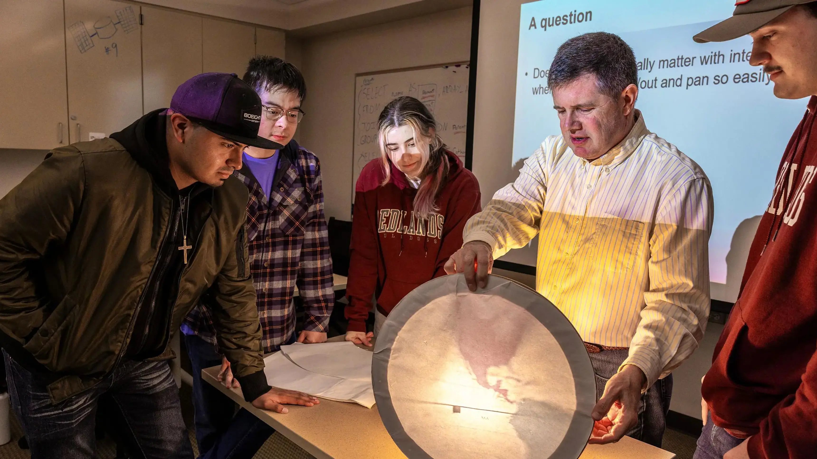 a group of people looking at a projector screen