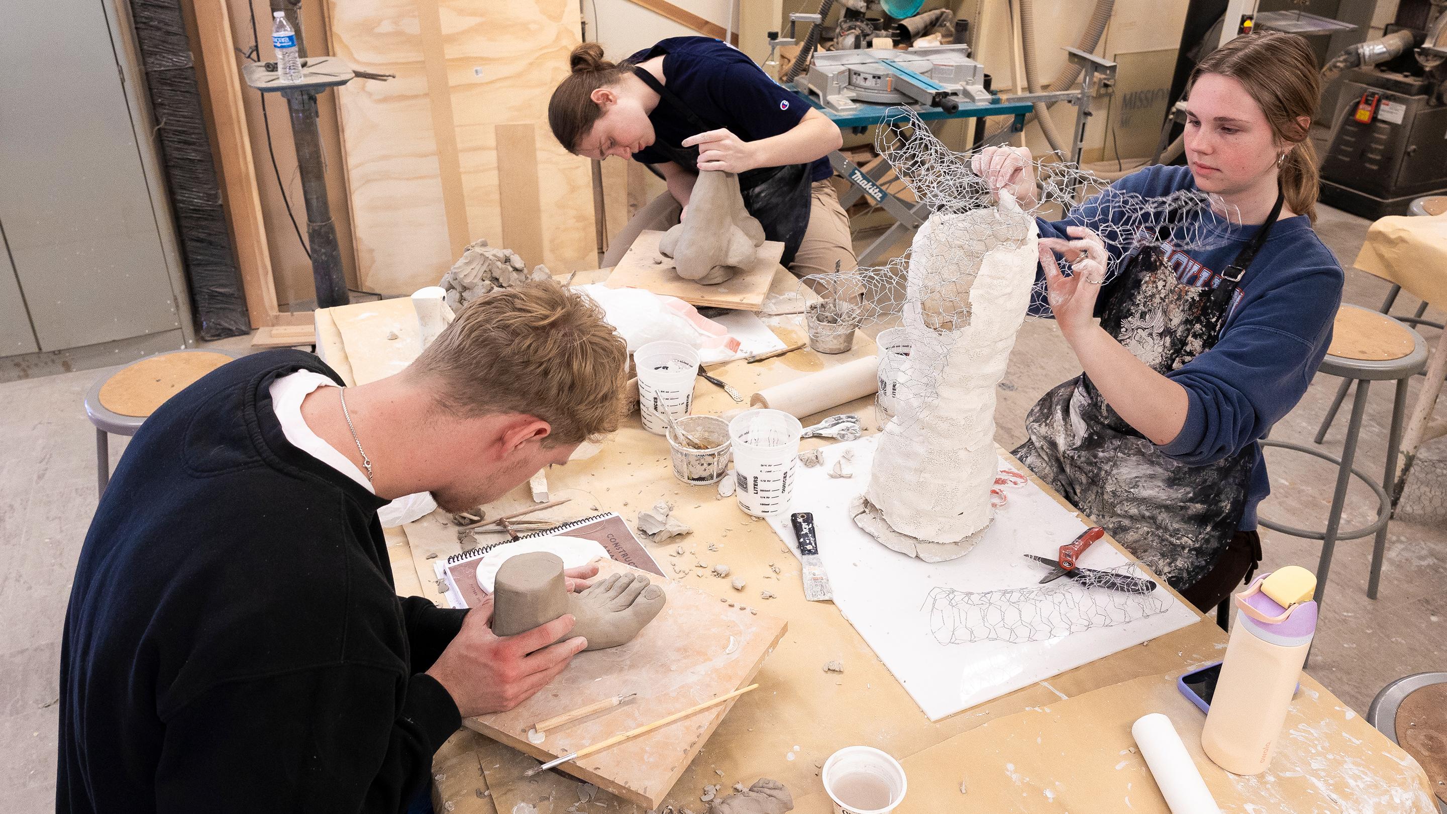 a group of people working on a sculpture