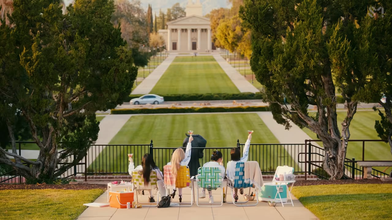 a group of people sitting on chairs in front of a building