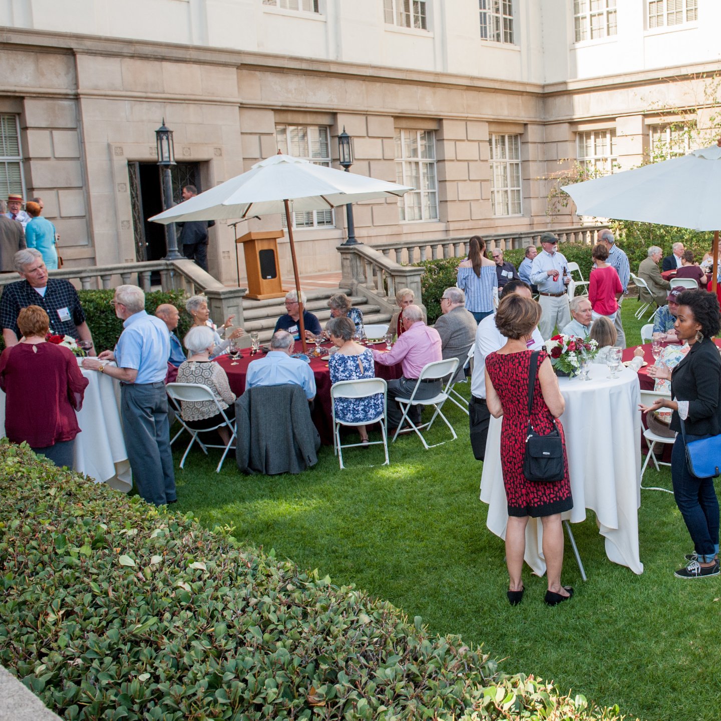 a group of people outside in a courtyard