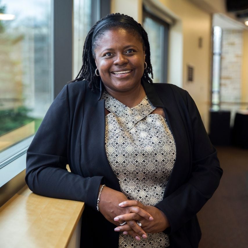 a woman leaning against a window