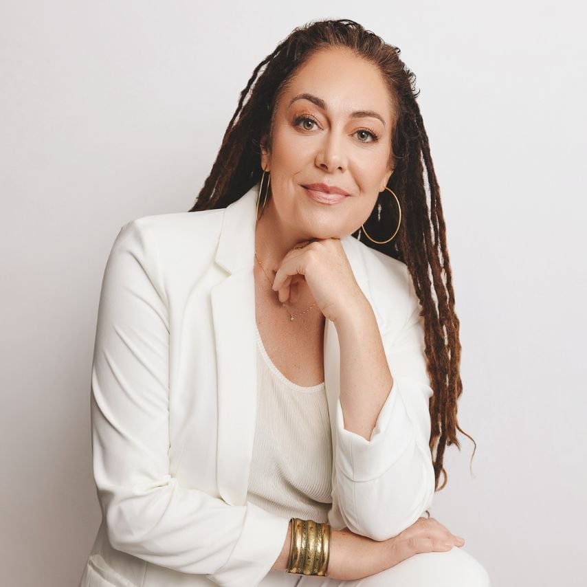 a woman in white suit with long dreadlocks
