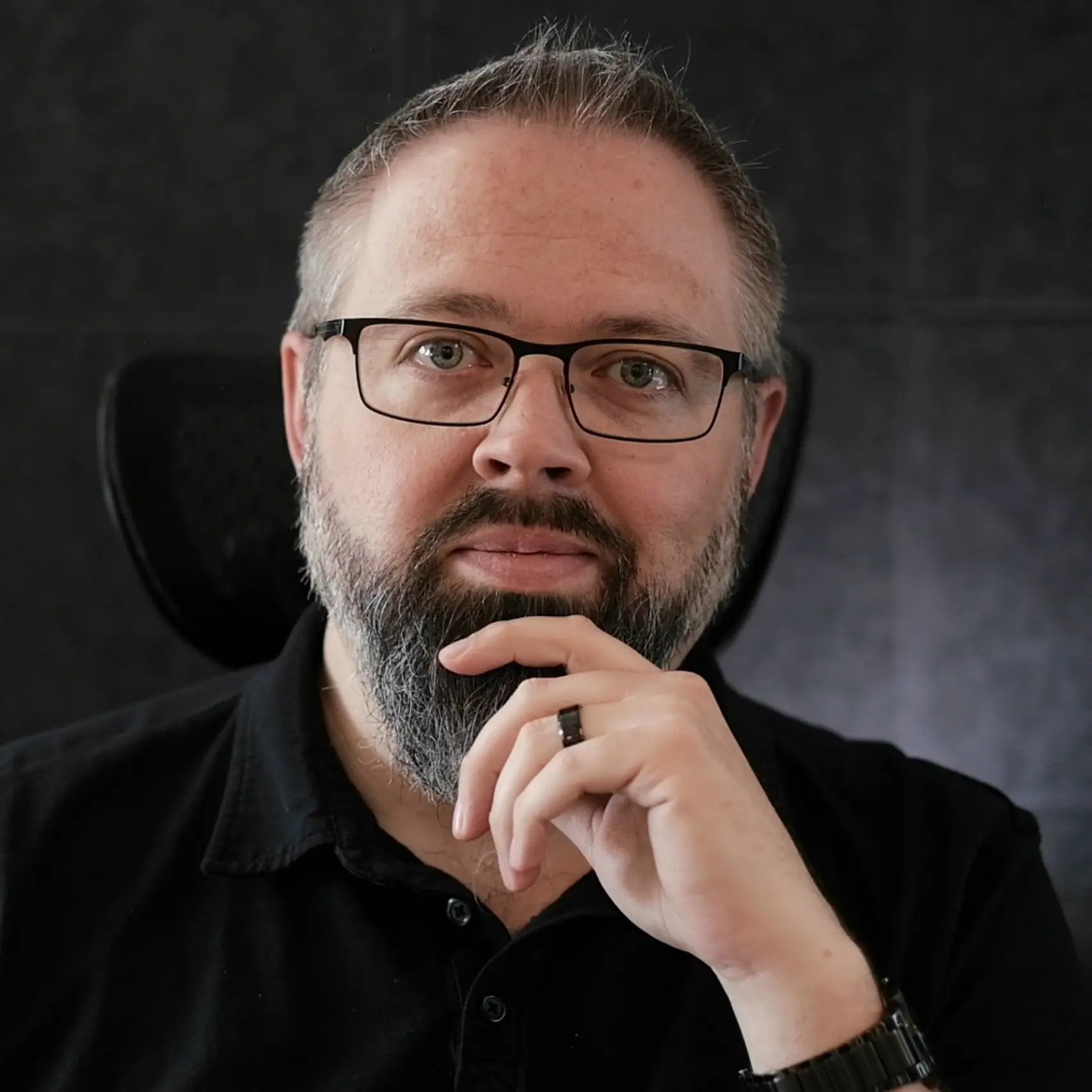 a man with a beard and glasses