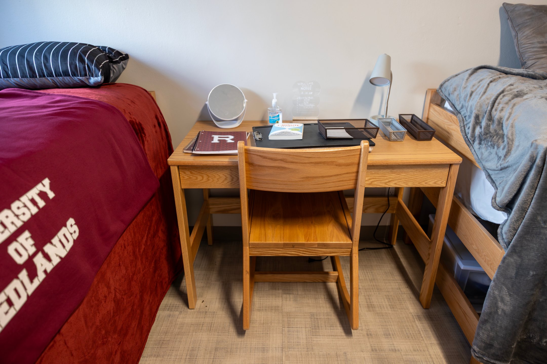 a desk with a chair and a mirror