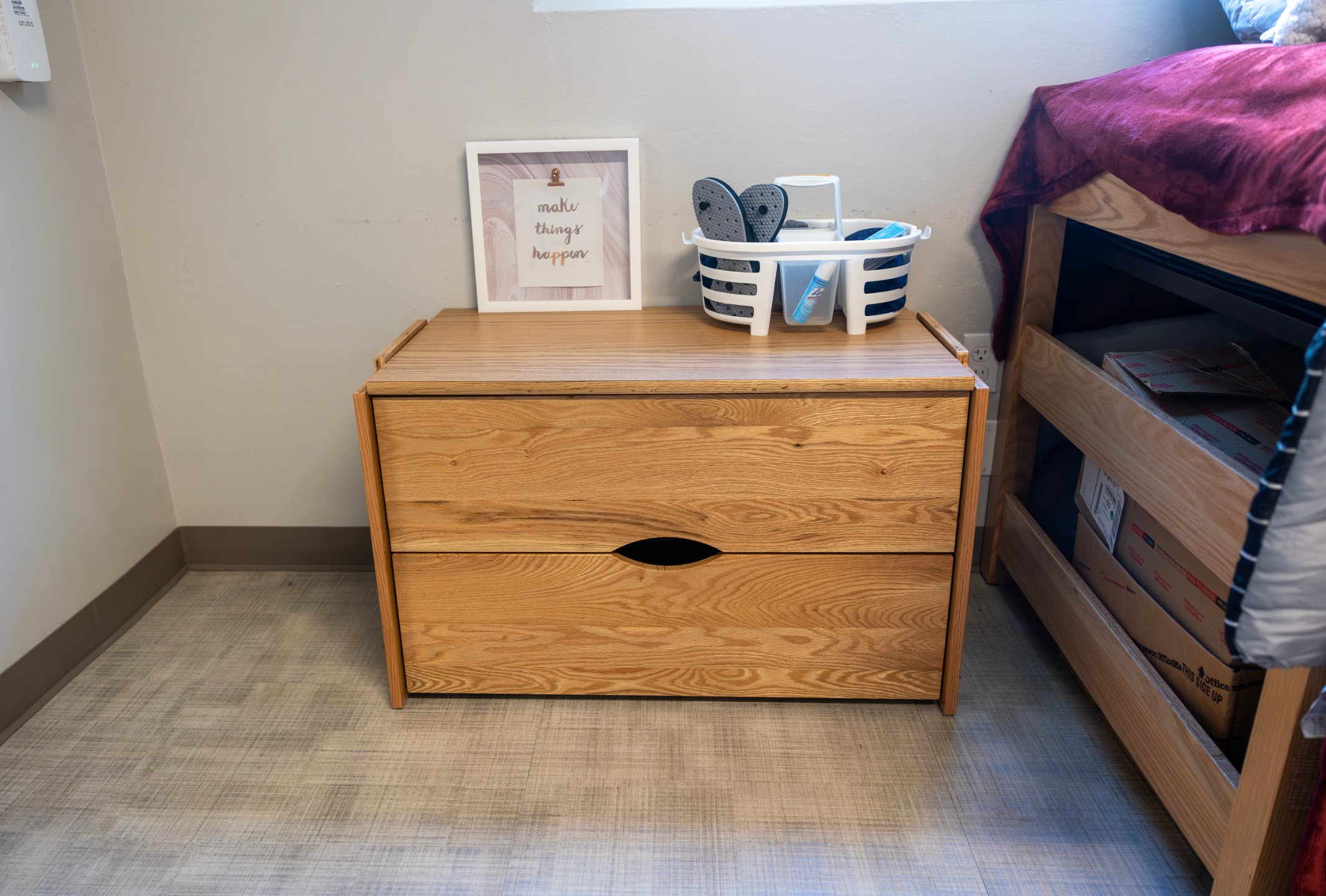 a wooden chest with a picture frame and a basket on top