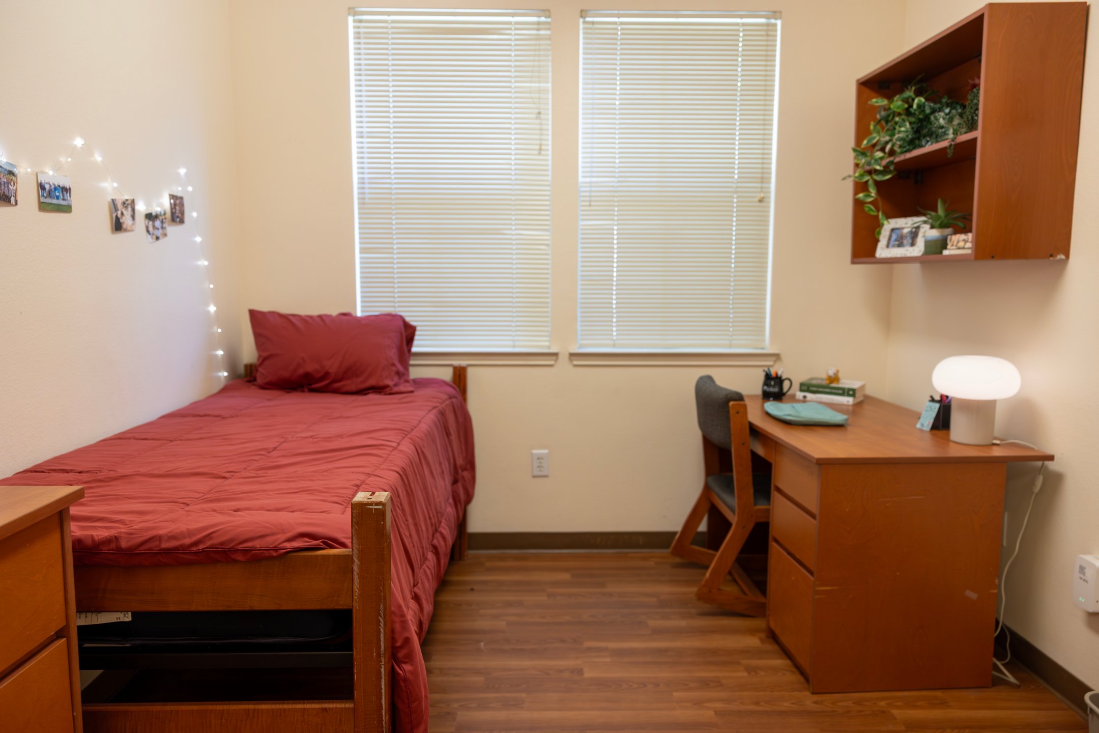 a bedroom with a desk and a bed