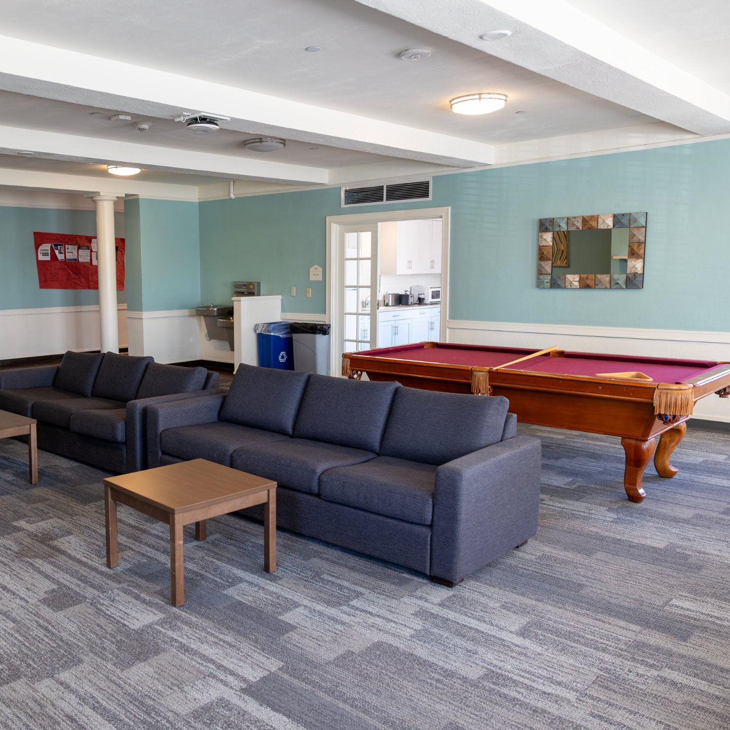 a pool table and couches in a room
