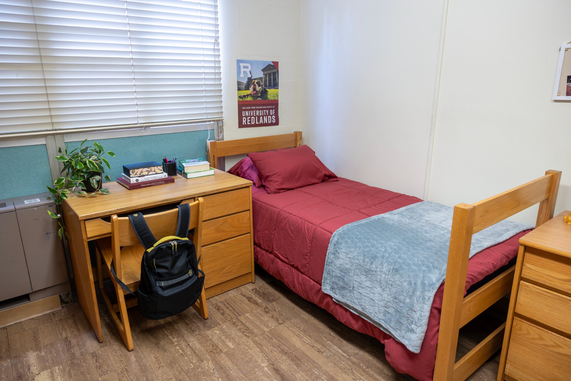 a small bed with a desk and chair in a room