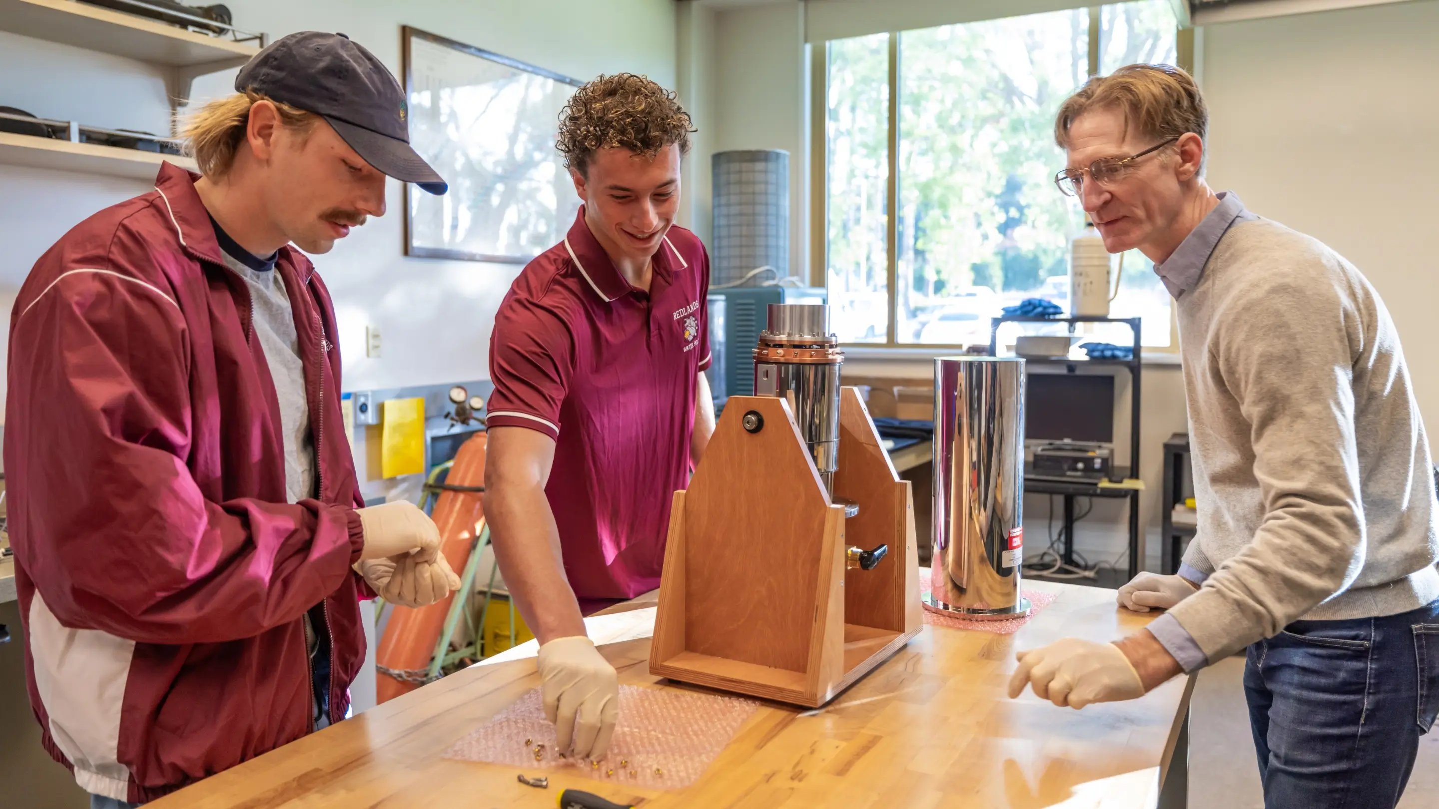 a group of men looking at a machine