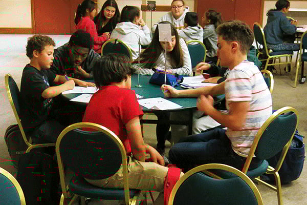 a group of people sitting around a table