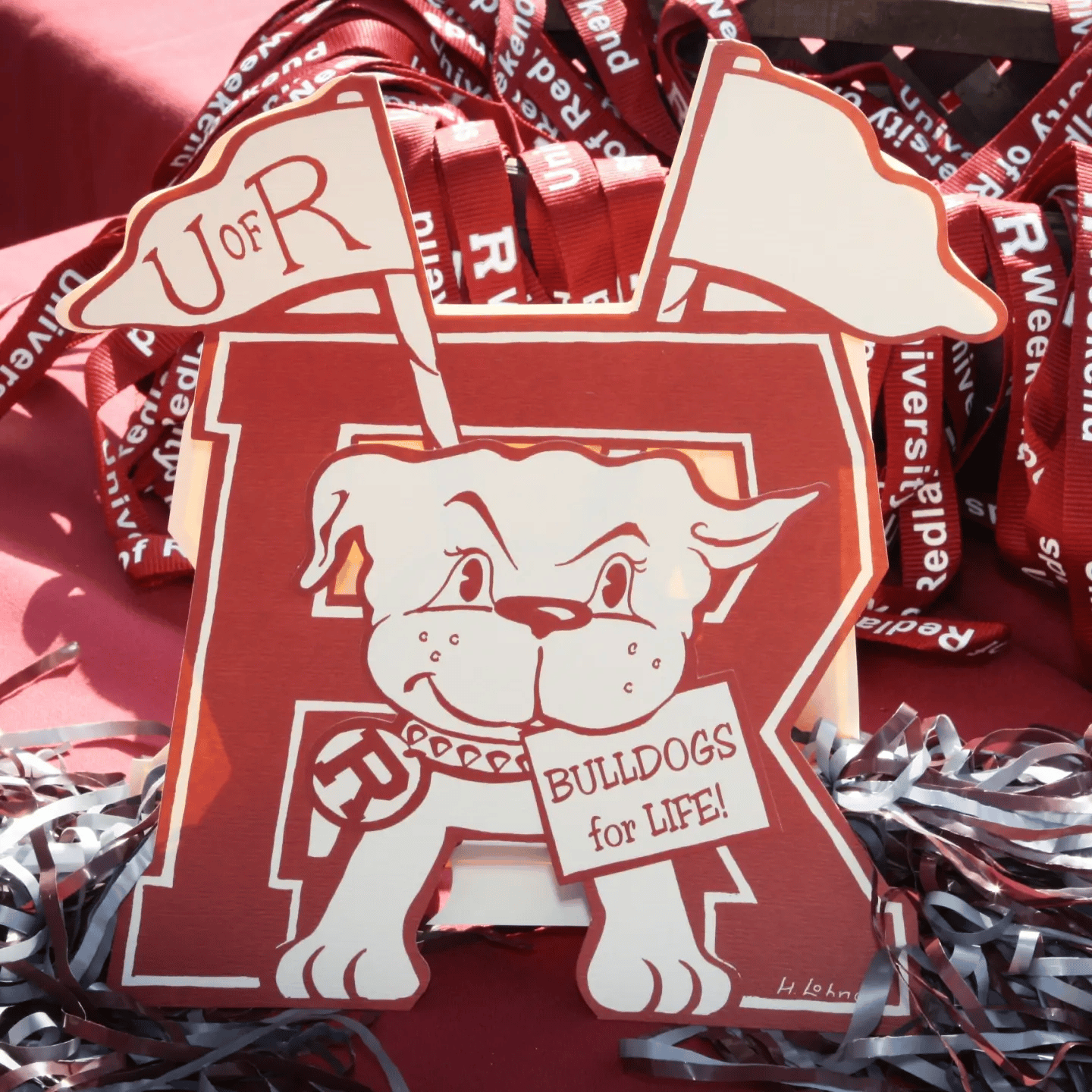 a red and white sign with a dog and a flag on it