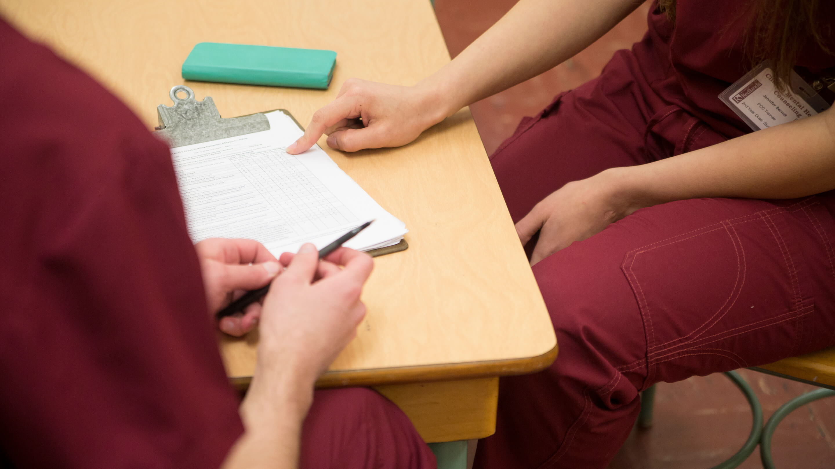 a person pointing at a piece of paper