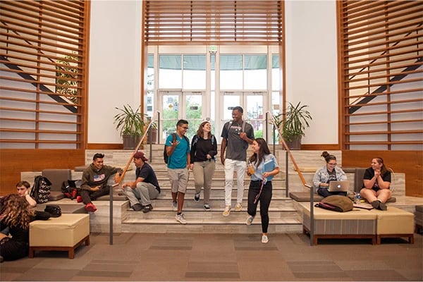 a group of people walking up stairs in a building
