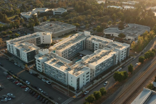aerial view of a building with cars parked in front of it