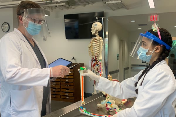 a couple of people wearing face masks and gloves