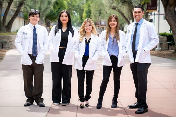 a group of people in white coats