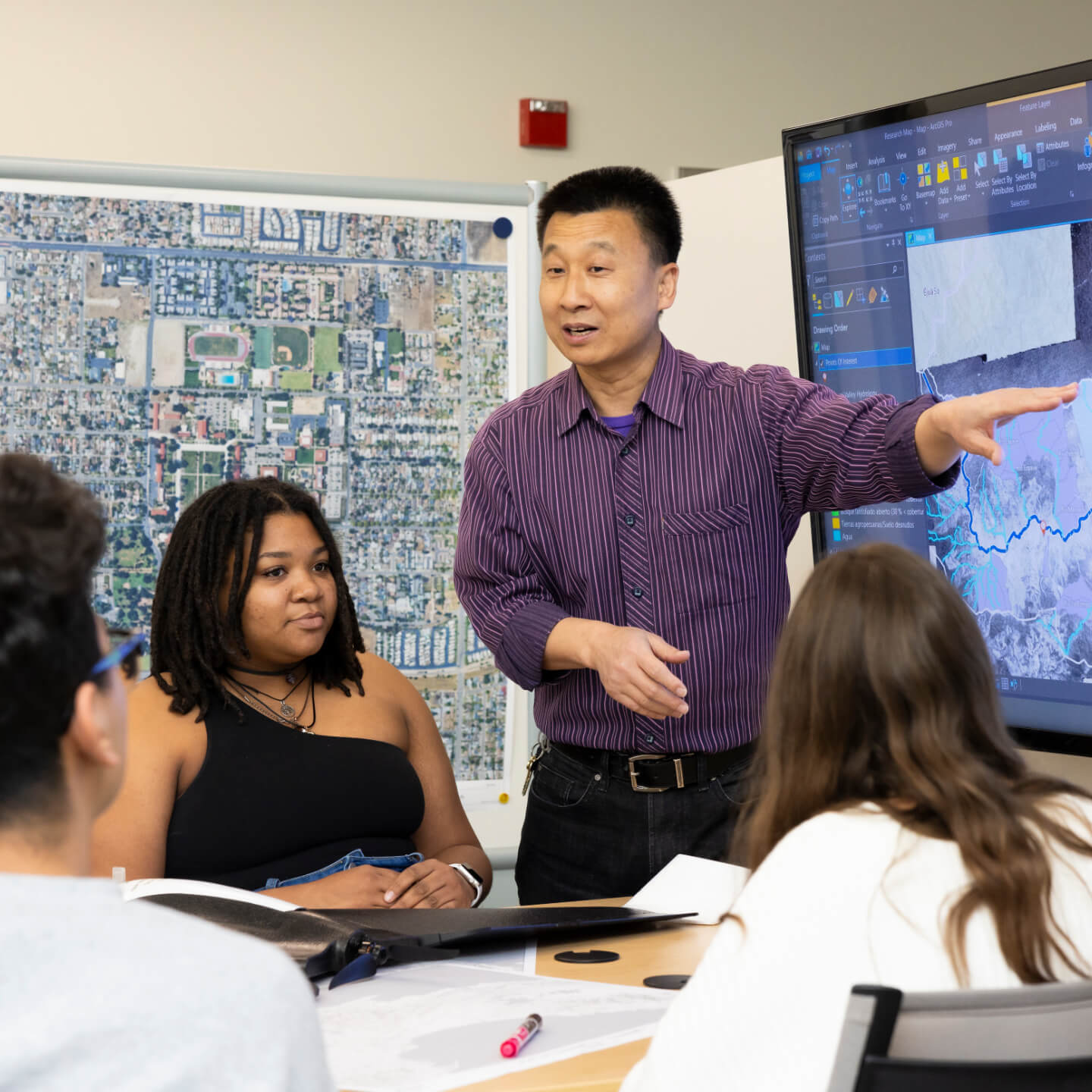 a man pointing at a screen