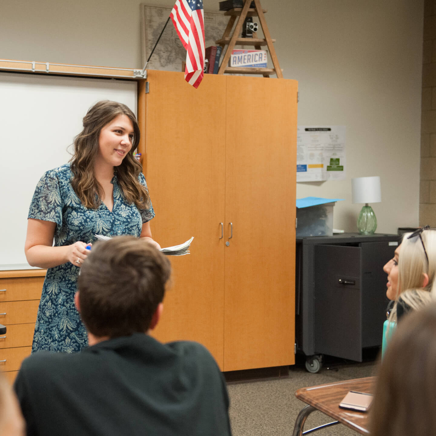 a woman standing in front of a classroom