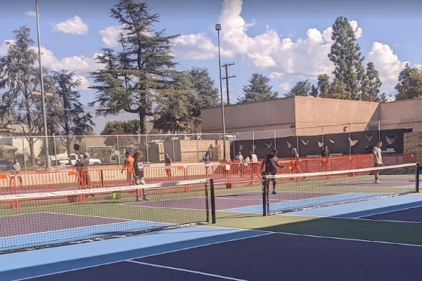 a group of people playing tennis