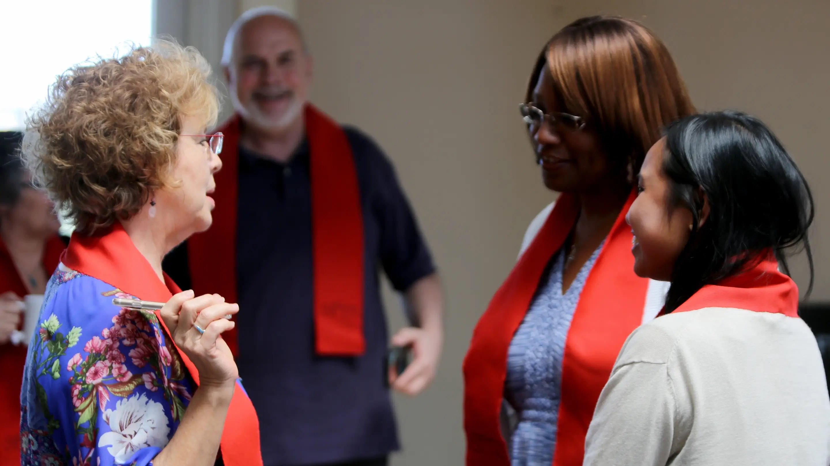 a group of people wearing red scarves