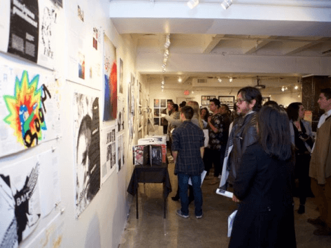 a group of people looking at a wall of posters