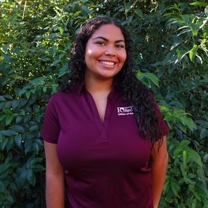 a woman in a maroon shirt