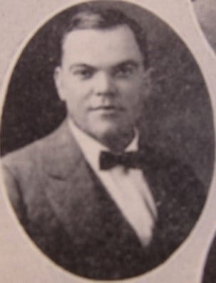 a man in a suit and bow tie