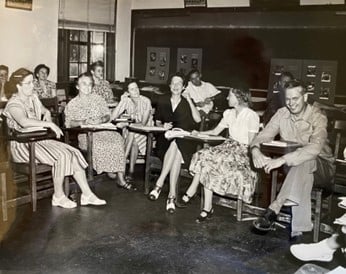a group of people sitting in a classroom